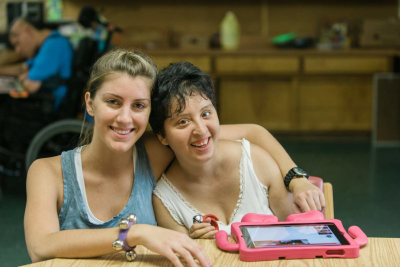 Female Volunteer smiling with female resident