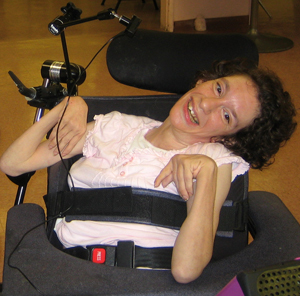 Hillside resident in wheelchair smiling at camera