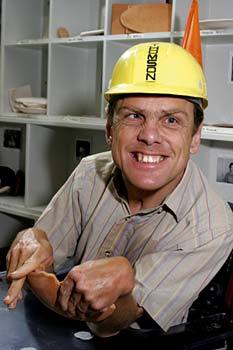 Hillside resident smiling while wearing a hardhat